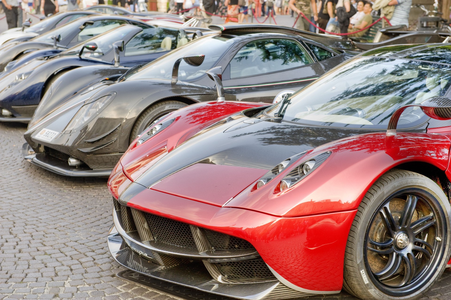 Pagani Huayra with other Pagani supercars in an Italian Piazza.